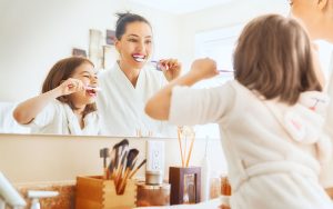 82 Dental - Father and daughter brushing their teeth