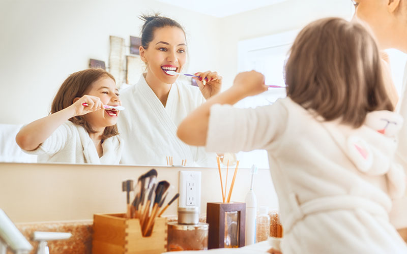 82 Dental - Father and daughter brushing their teeth